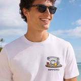Man wearing a white t-shirt with the Hammered Shark logo and olive cargo shorts standing on a beach. Close up